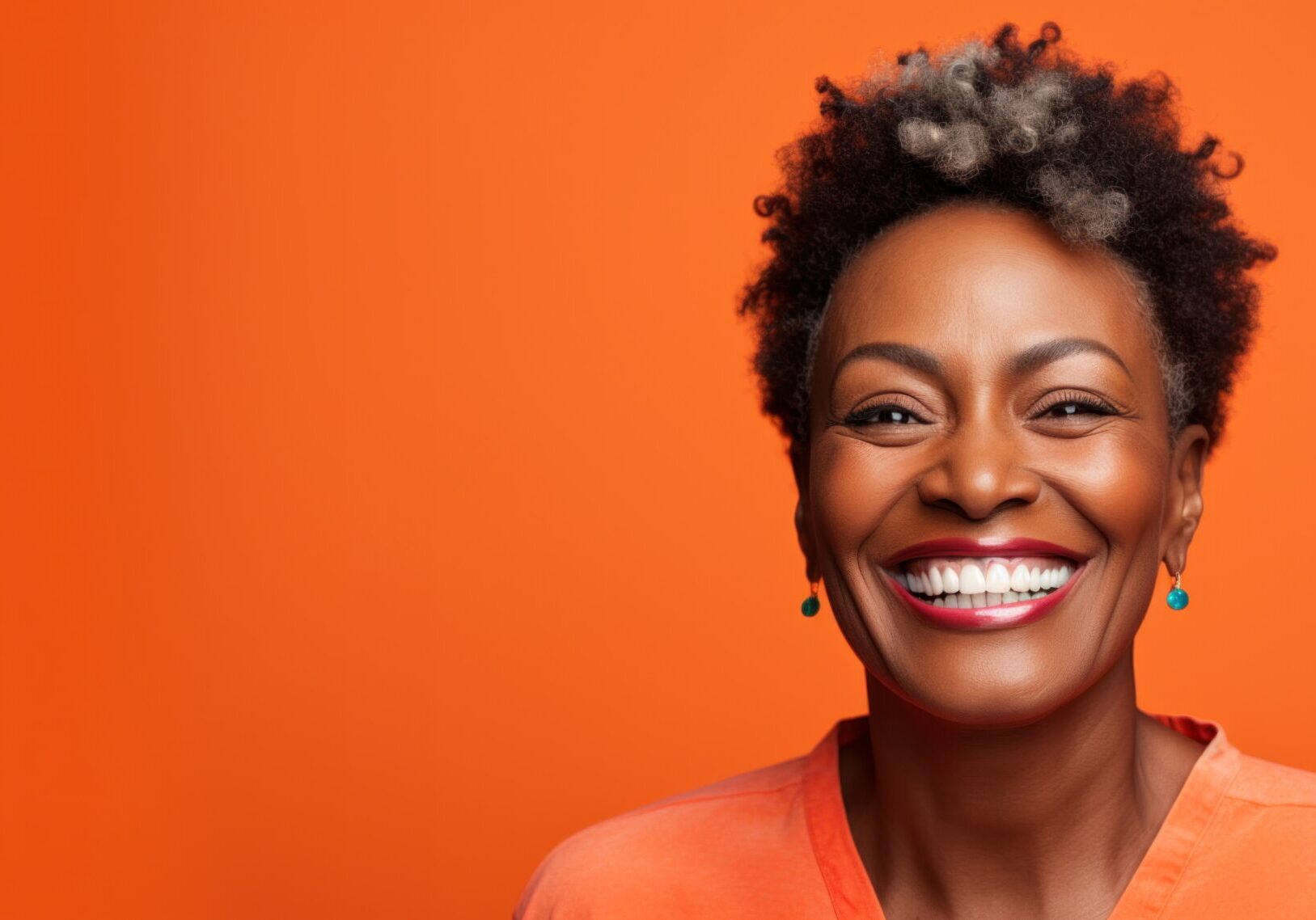 A woman smiling with her teeth showing.